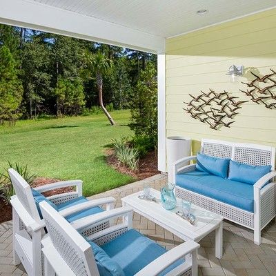 Veranda with a sofa and two armchairs