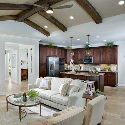 Large room with kitchen, table and sofa