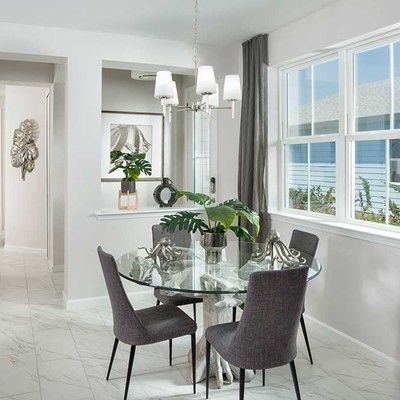 Room with a round glass table and 4 chairs