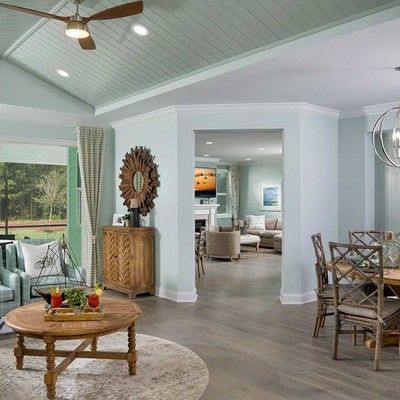 Room with a large table, chairs and a sofa