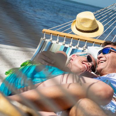 Man and woman lie in a hammock