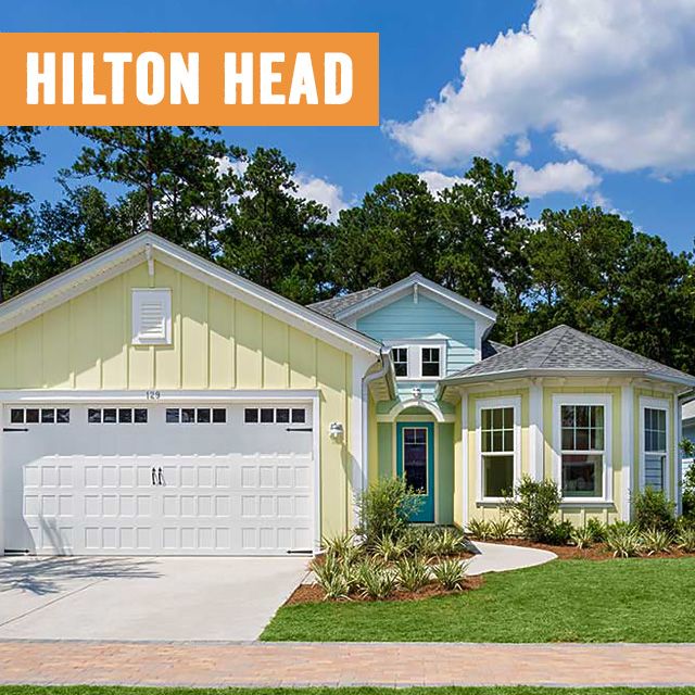 picture of an island-inspired ranch style home with pastel yell and robins egg blue accents