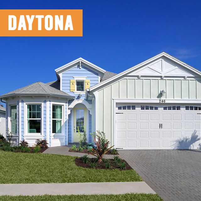image of the Dayton Beach Breeze model home, painted in sea blue and sea foam colors and white trim with manicured landscaping