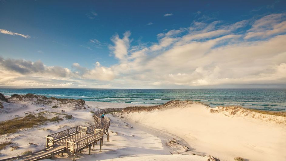 Raised boardwalk going towards a beautiful beach