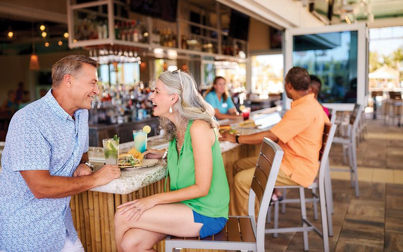 Couple sitting at the Change in Latitude bar in Latitude Margaritaville Daytona Beach