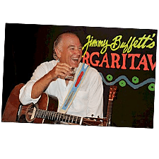 Photo of Jimmy Buffett with a guitar