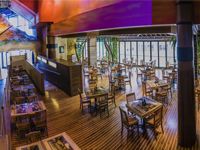 Aerial view of the Euphoria deck - Wooden floor with tables and chairs, high ceilings