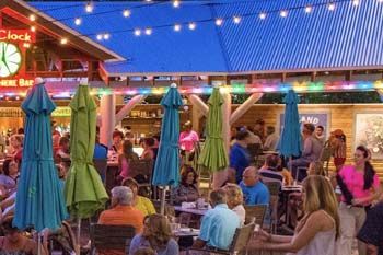 Large group of people inside Margaritaville mingling, drinking and eating