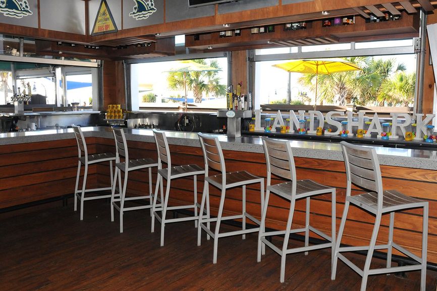 Landshark bar with bar stools and windows with view of the outside