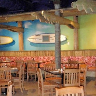 Photo of second-floor restaurant seating area decorated with surfboard wall art