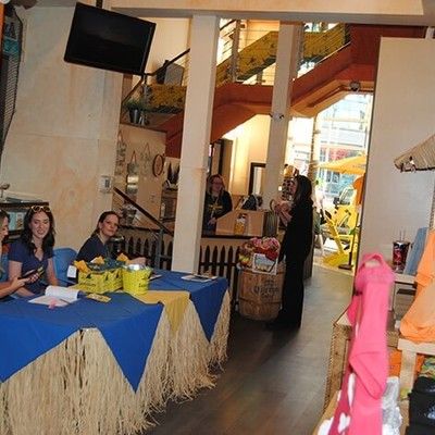 Event registration table with staff welcoming guests inside the venue