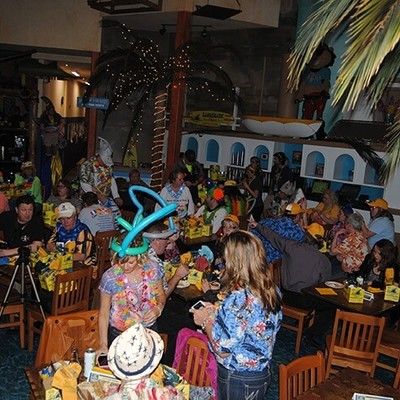 Overview of guests seated at tables inside a decorated restaurant venue