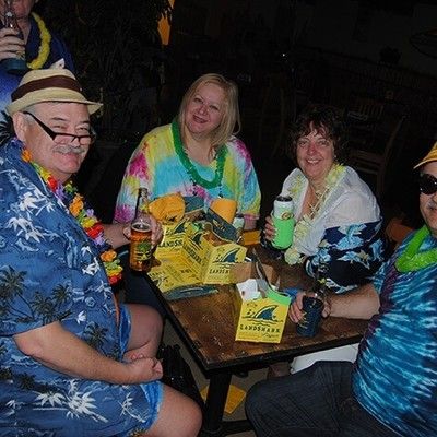 Friends sitting at a table with drinks enjoying a festive gathering