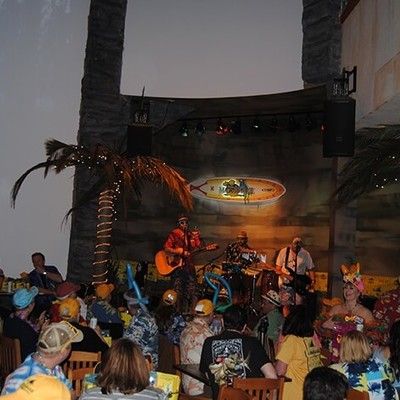 Live musical performance on stage inside a crowded restaurant