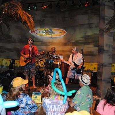 Live band performing acoustic songs on stage for party guests