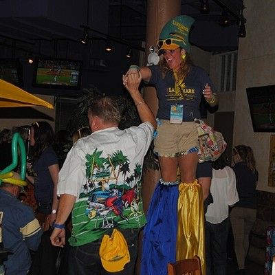 Stilt walker dancing with party guests inside the restaurant