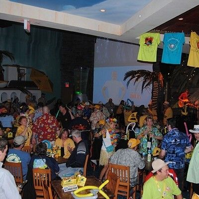 Wide shot of party guests enjoying a festive night with live music inside the venue