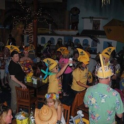 Guests wearing yellow party hats celebrating inside the restaurant