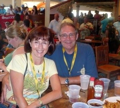 Smiling couple sitting at a restaurant table with drinks during an event