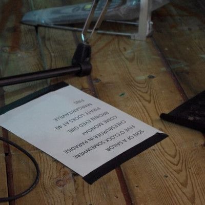 Concert setlist printed on paper placed on the stage floor