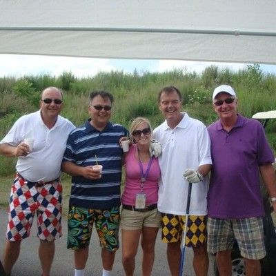 Group of golfers in colorful Loudmouth shorts posing together outdoors