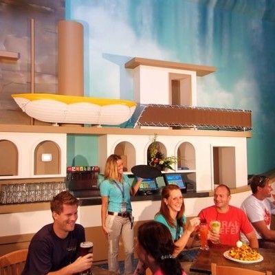 Restaurant server taking orders from guests sitting near the Maid of the Mist boat decor