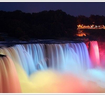 Illuminated Niagara Falls flowing at night with colorful lights