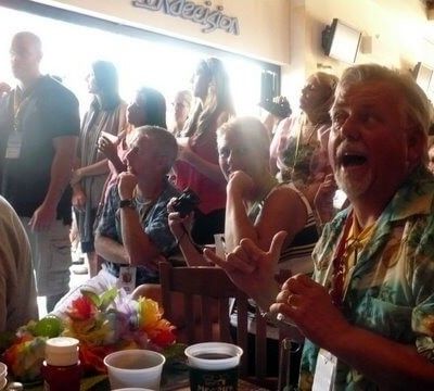 Excited fan making a shaka hand gesture during a live performance
