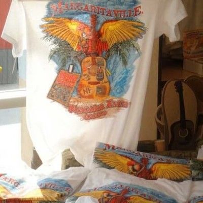Photo of Margaritaville Niagara Falls souvenir t-shirts displayed on a rack