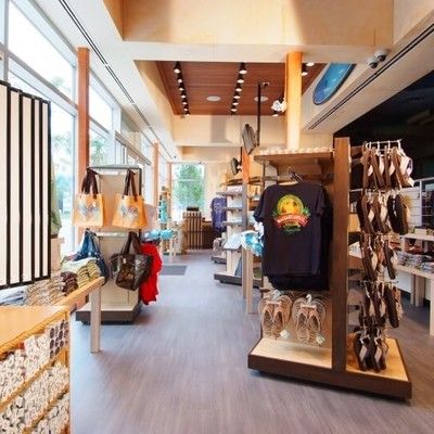 Interior of the retail shop with clothing, footwear, and souvenirs on display racks