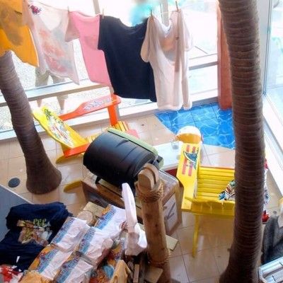 Photo of Margaritaville retail surf shop displaying beach apparel, shirts, and beach chairs