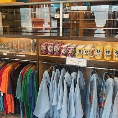 Display of Margaritaville hoodies, shirts, and branded souvenir mugs