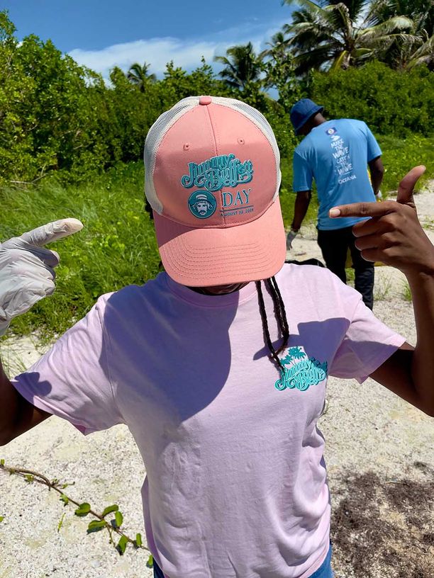 A person with their head down to show their Jimmy Buffett Day hat