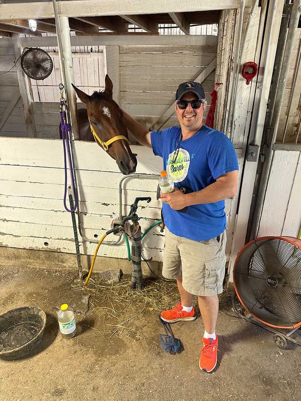 A man petting a horse