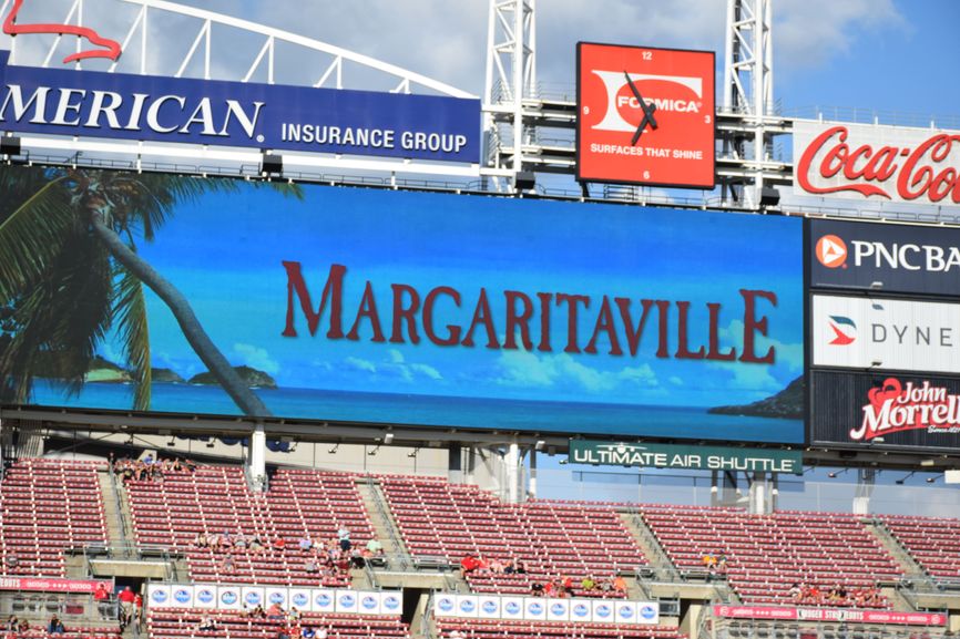 The outfield scoreboard at a baseball stadium displaying a tropical Margaritaville graphic