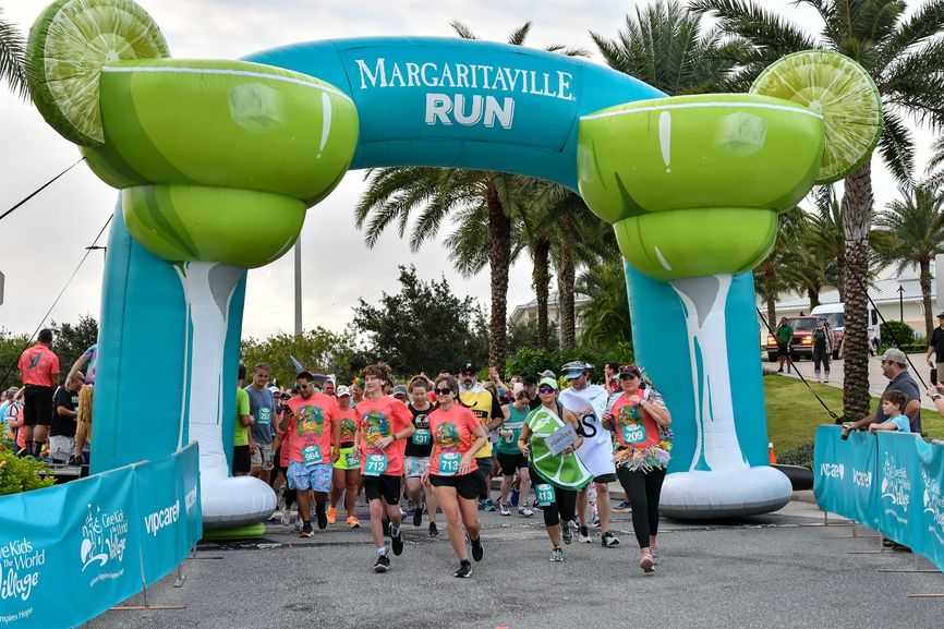 Runners begin a MARGARITAVILLE RUN by passing under a large inflatable archway