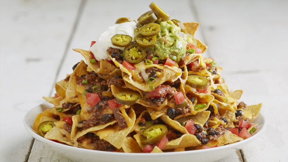 Our signature Volcano Nachos on a white plate