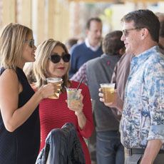 Group of people at an event with cups of LandShark Lager