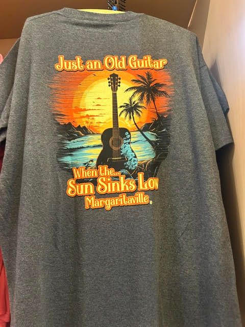 Grey t-shirt with a sunset, acoustic guitar, and palm trees reading 'Just an Old Guitar When the Sun Sinks Low'