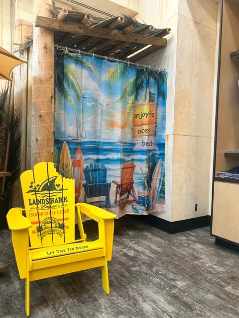 Yellow LandShark miniature wooden Adirondack chair display with beach curtain background