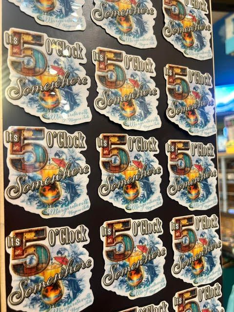 Display board covered with 'It's 5 O'Clock Somewhere' tropical drink magnets