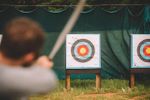Axes and Archery Student with bow and arrow aiming at target