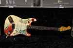 Monterey Fender with intricate red and teal design on body with amps Monterey Fender with intricate red and teal design on body with amps