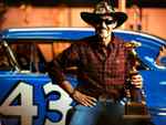 Petty with his 57 Oldsmobile with a trophy 