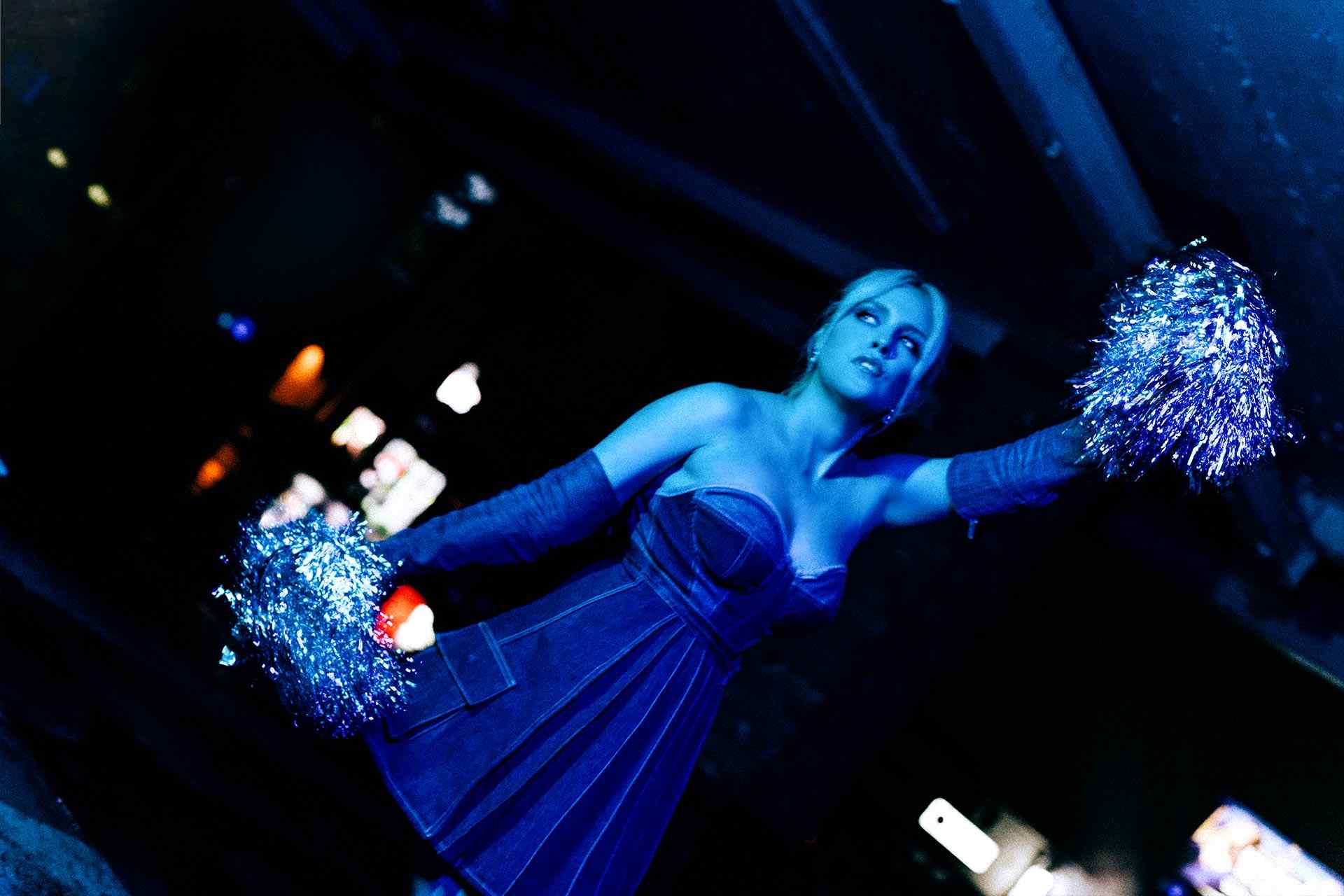 Eden with pom poms doing an apathetic cheer 5.jpg