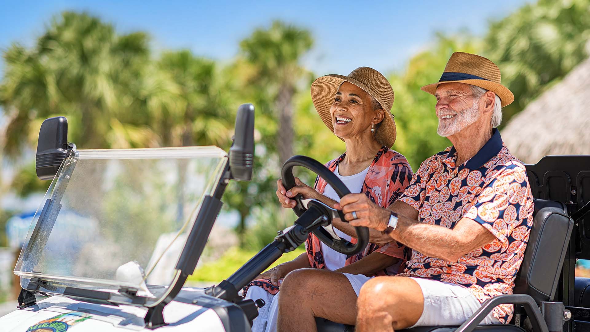 hero_5.jpg An older couple driving a golf cart.