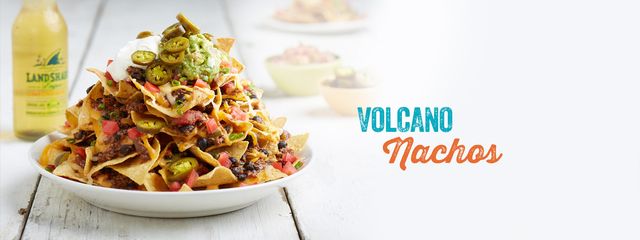 Volcano nachos piled high on a white plate