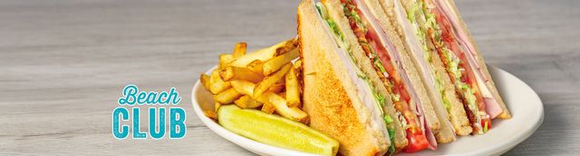 Beach Club Sandwich with fries and a pickle