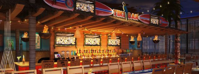 Inside Tiki Bar with string lights and multiple tvs