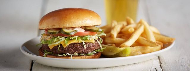 Cheeseburger in Paradise with french fries and a pickle